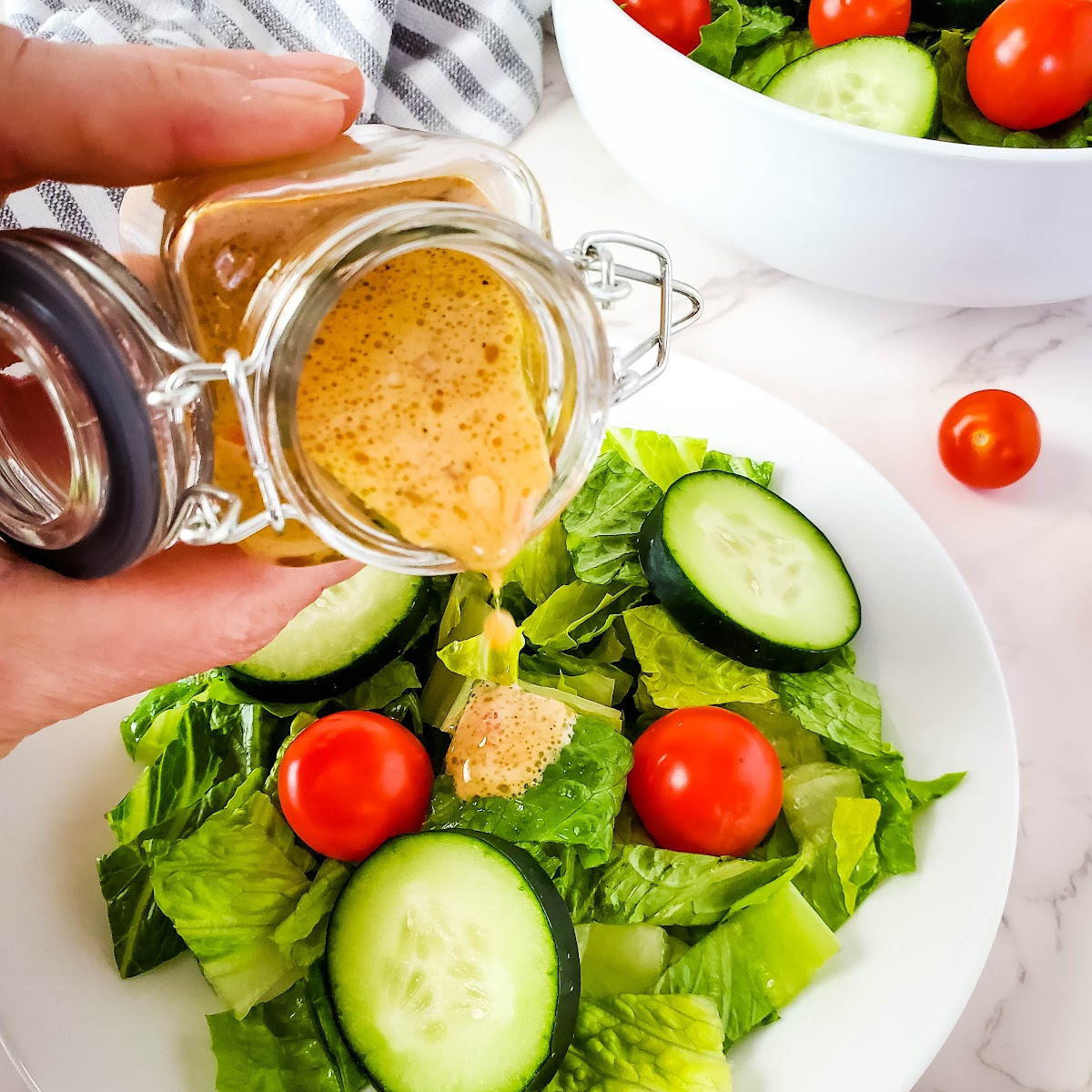 feature image of homemade dressing over salad