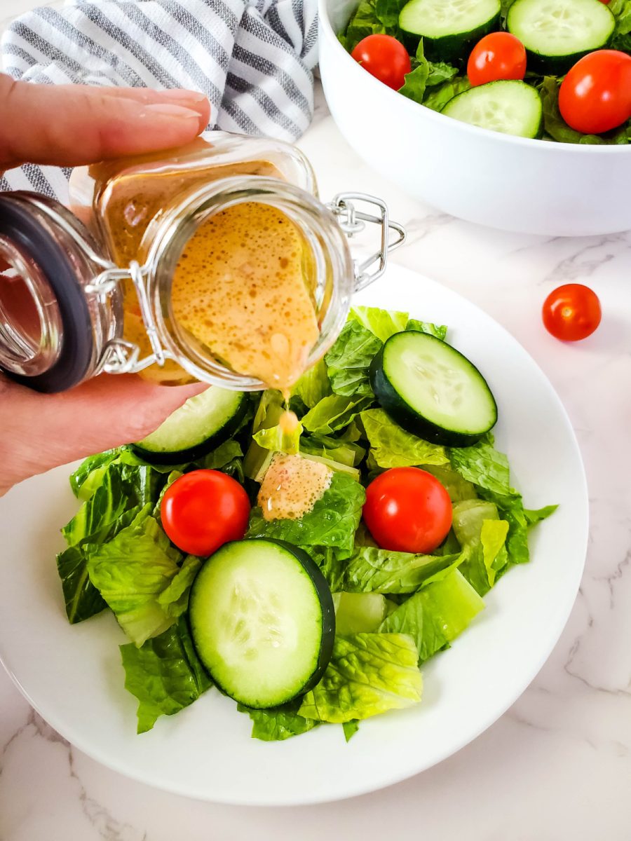 pour red wine salad dressing over a tossed salad