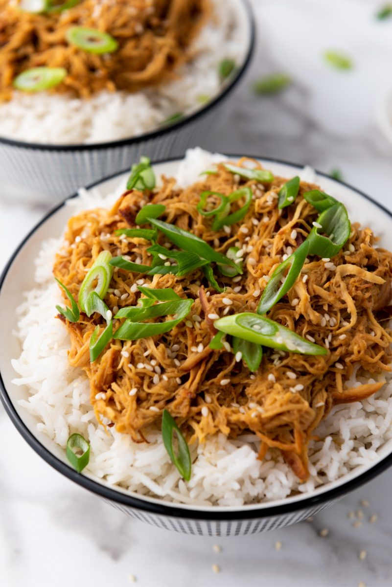 close up of bowls of honey sesame chicken with rice