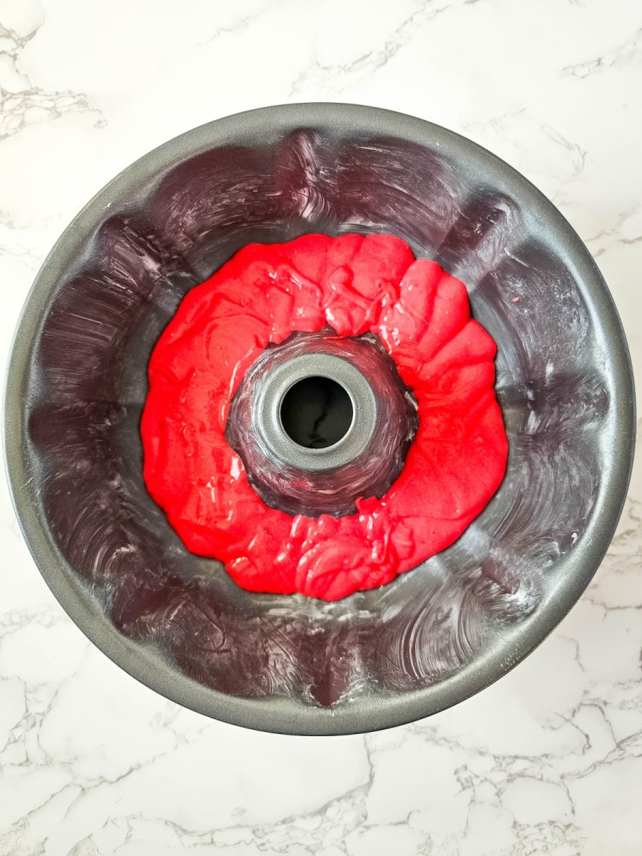 pour red cake batter in bottom of bundt pan