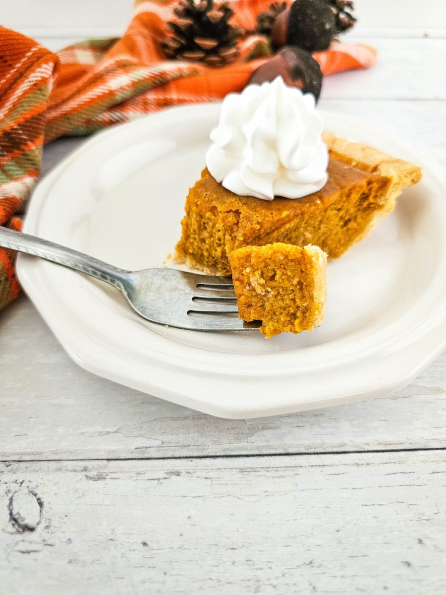 fork with pumpkin pie on it on plate