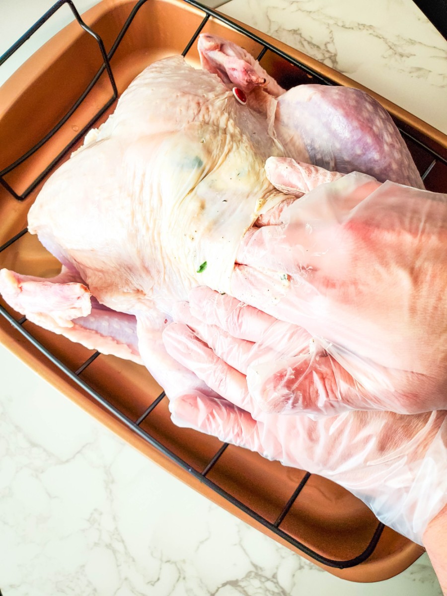 gently lifting turkey skin to put butter mixture under
