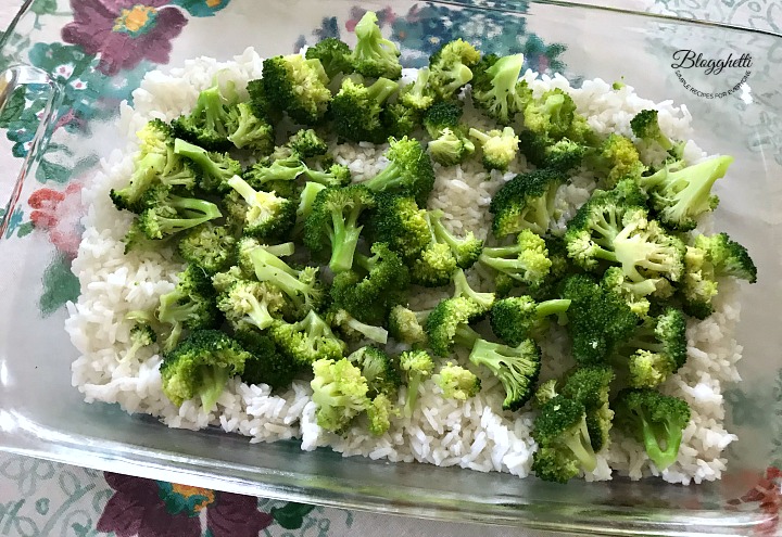 layering the broccoli on the rice in the casserole dish