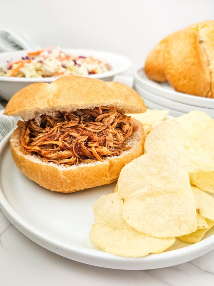 barbecue chicken sandwich on plate with chips