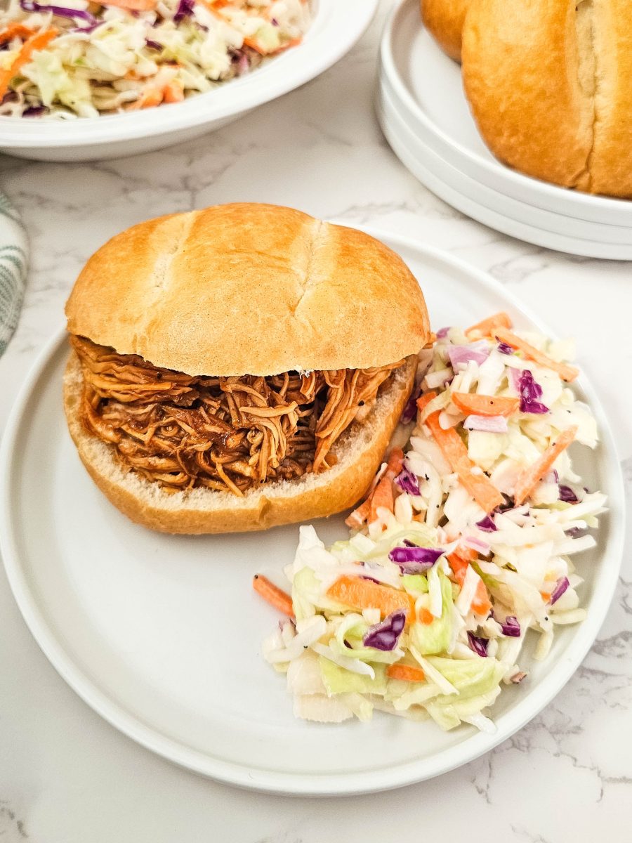 bbq chicken sandwich on plate with coleslaw