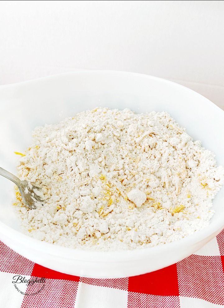 white bowl with flour mixture and cheese for biscuits