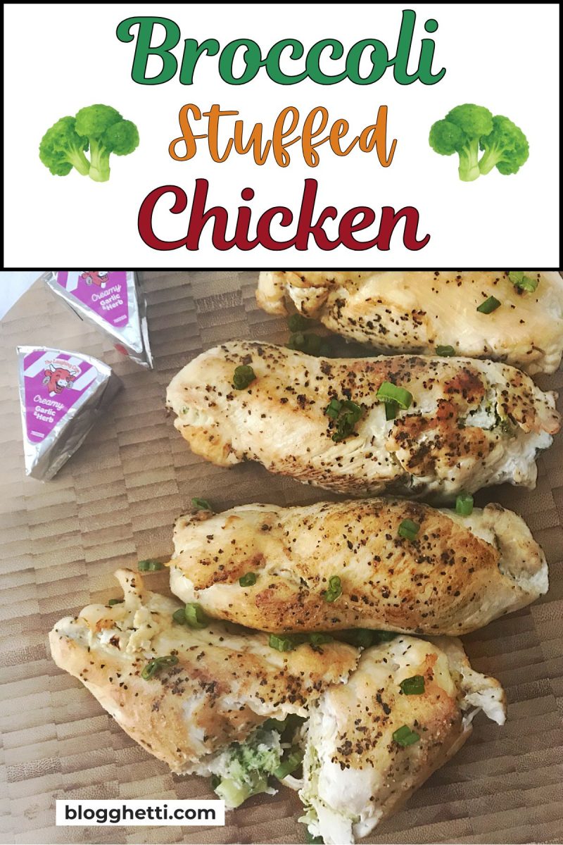 A wooden board holding four Broccoli Stuffed Chicken breasts garnished with green onions and shown with cheese wedges.