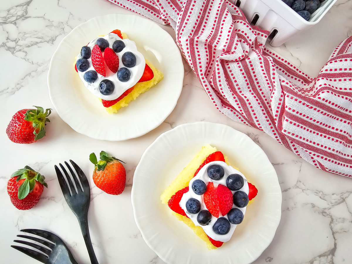 plates with lemon bars strawberries and blueberries