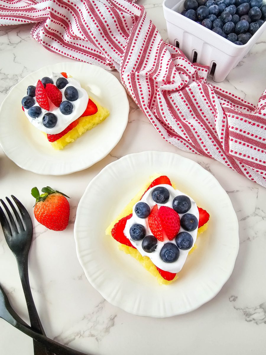 two plates with lemon bars and fresh berries