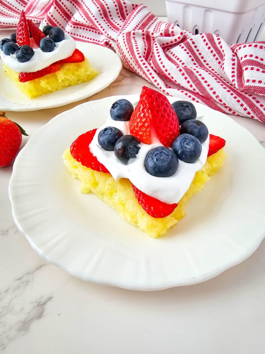 white plate with lemon bar and berries