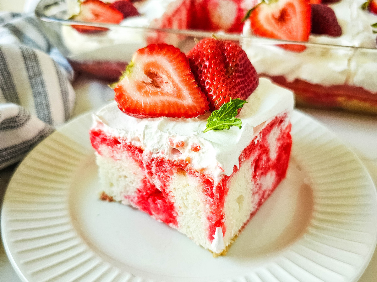 close up of strawberry jello poke cake slice