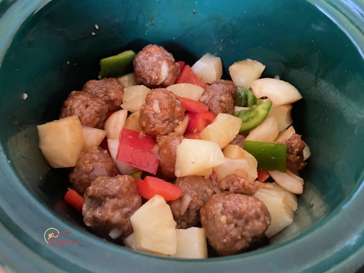 sweet and sour meatballs and vegetables in crockpot ready to cook
