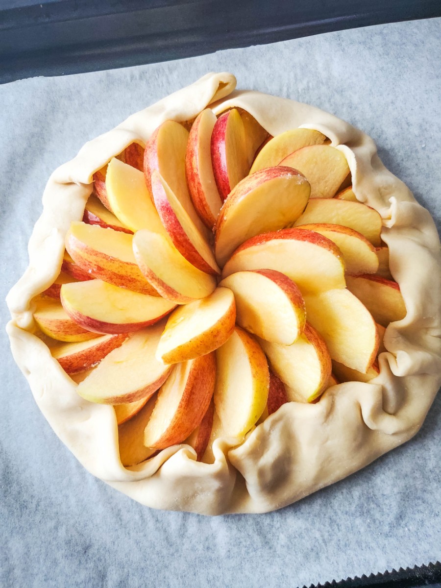 bringing the edges of crust up to the apples