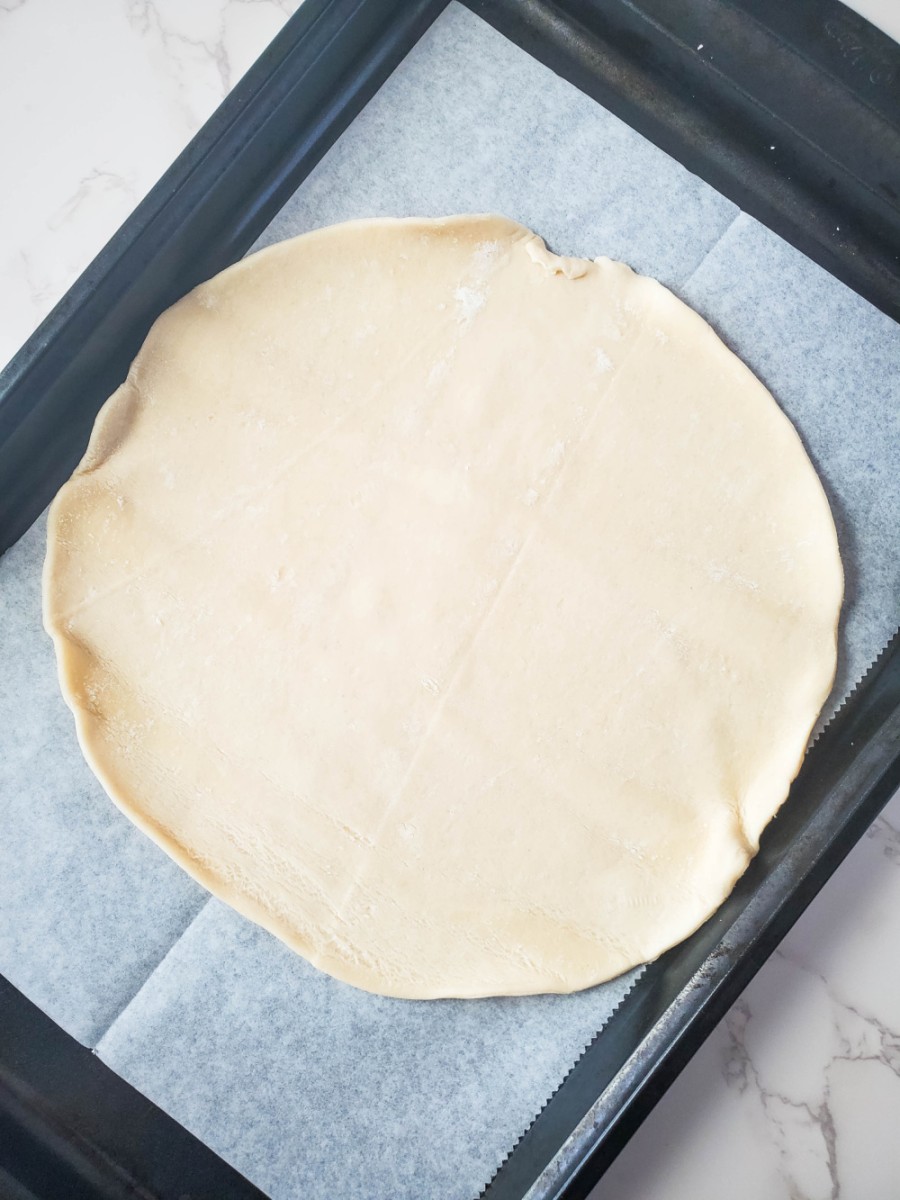 place prepared pie crust on baking sheet