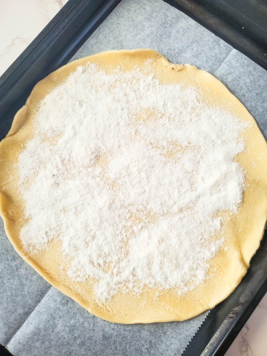 sprinkle the sugar and flour mixture over pie crust