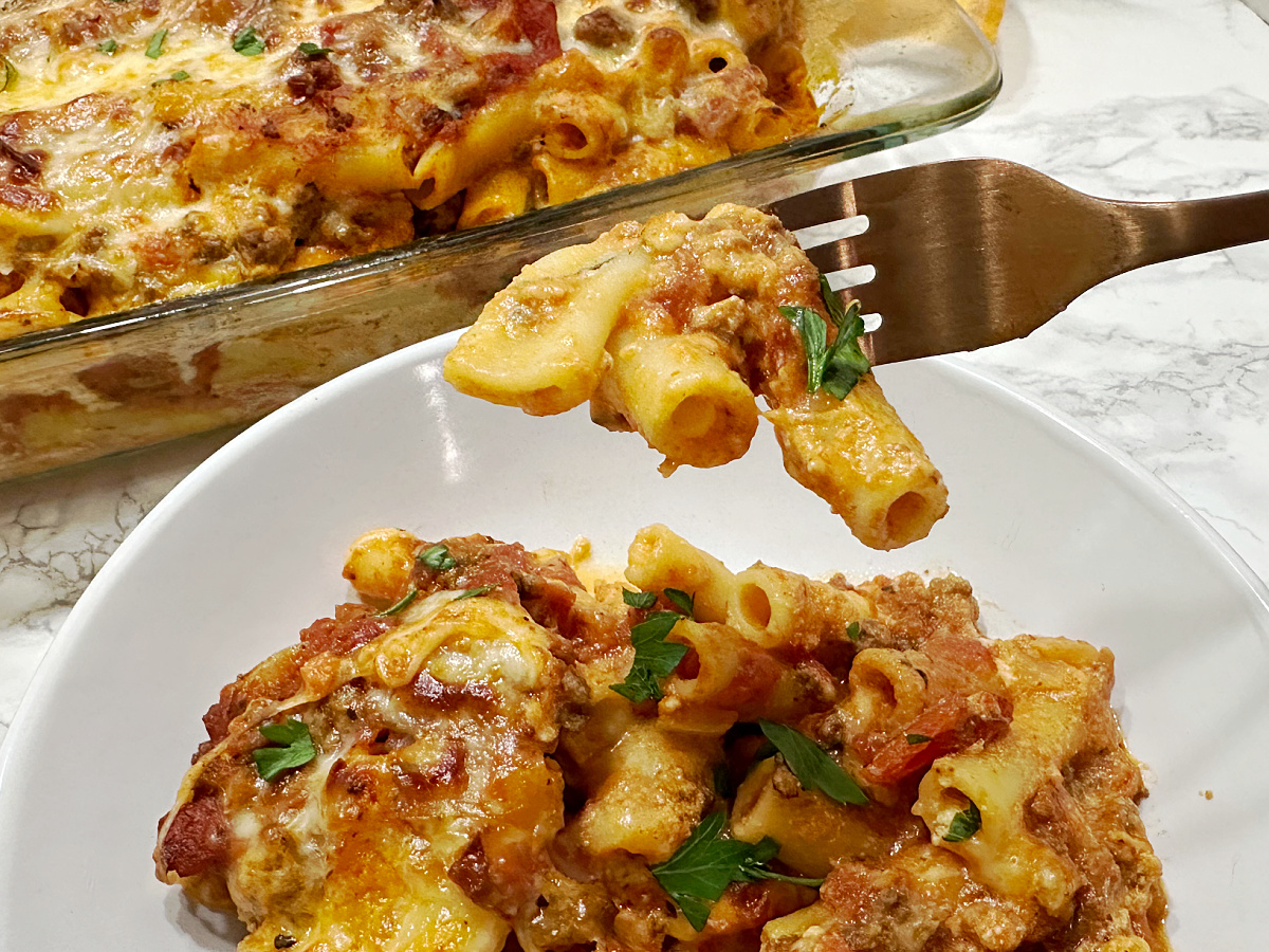 close up of fork with pasta and sauce