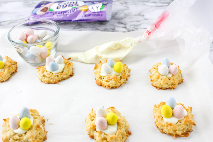 filling coconut nests with white chocolate and candy eggs