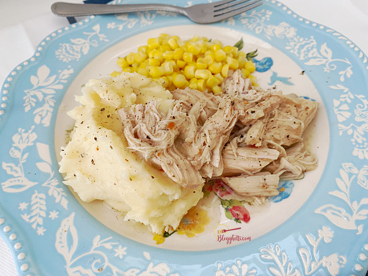 blue plate with slow cooker Italian chicken, mashed potatoes and corn