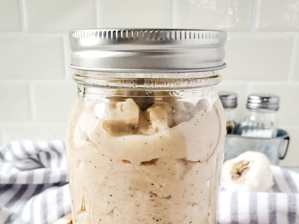 close up glass jar filled with cream of chicken condensed soup