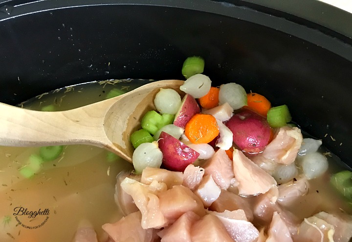 preparing chicken pot pie soup in the slow cooker