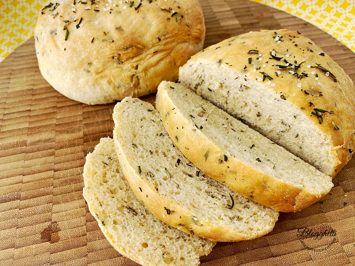 sliced rosemary bread on cutting board