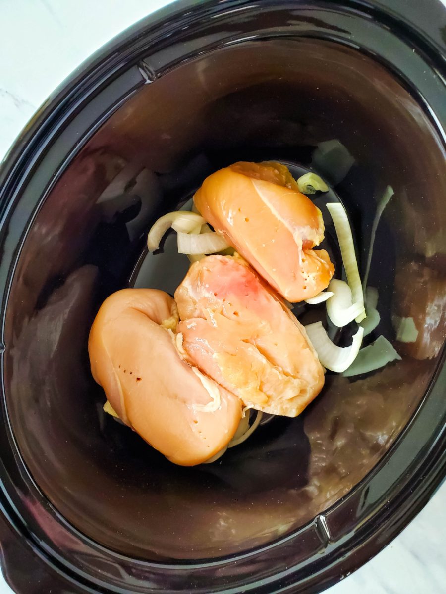 top onions with chicken breasts in slow cooker