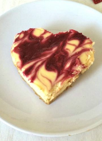 This easy White Chocolate Raspberry Cheesecake is perfect for the loves of your life! TThe white chocolate gives the cheesecake just a tad more richness, while the raspberry adds a bit of tart with sweet to the whole wonderful dessert. This is so easy that anyone can do it!