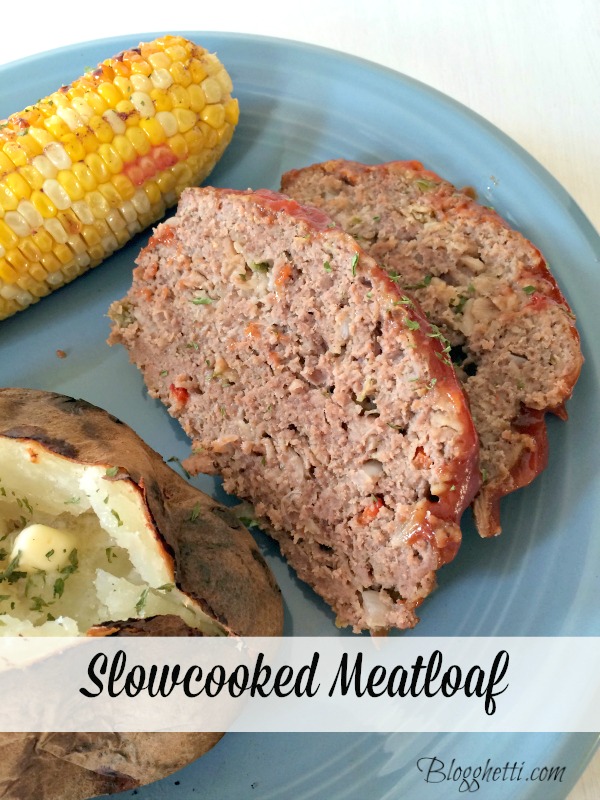 slow cooked meatloaf on a blue dinner plate with corn and baked potato