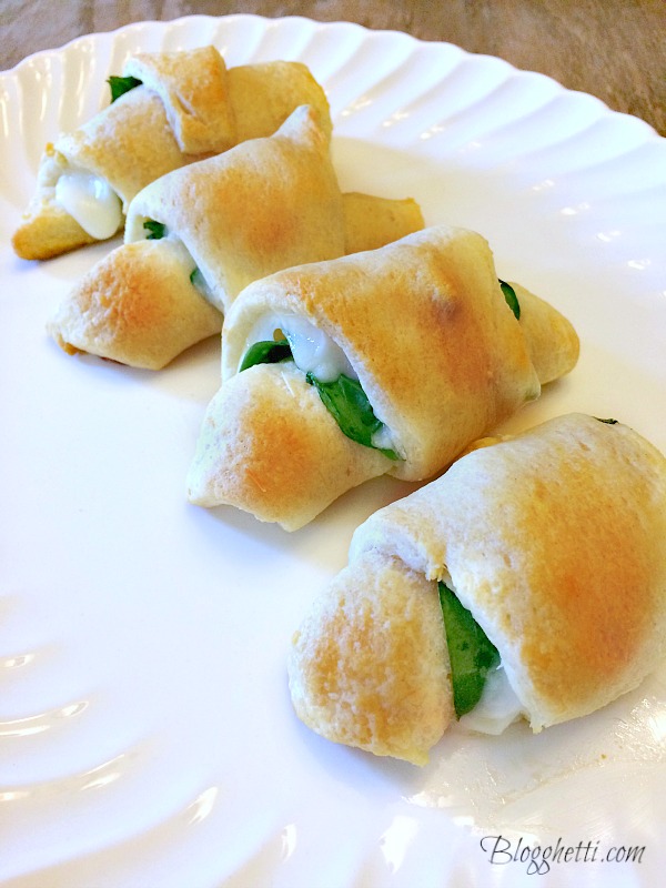 Light and fluffy crescents are loaded with cheese and spinach and make an easy appetizer or light lunch with a salad. #spinach #cheese #appetizer #crescents #meatlessmonday