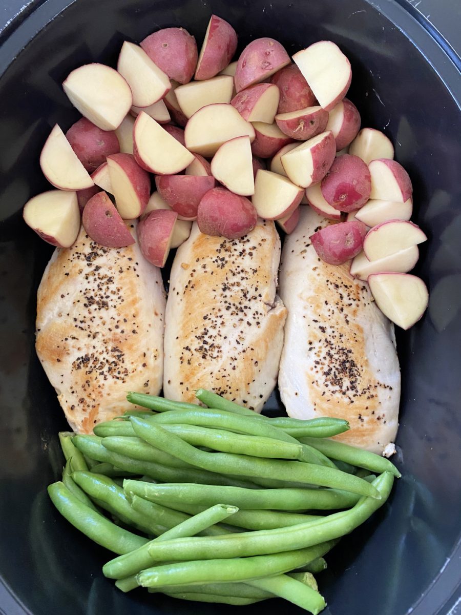 add vegetables and chicken into slow cooker