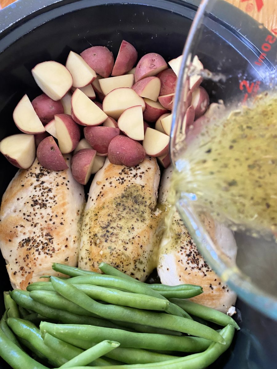 pour lemon dressing over chicken and veggies