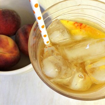 glass of peach green tea made with homemade peach simple syrup
