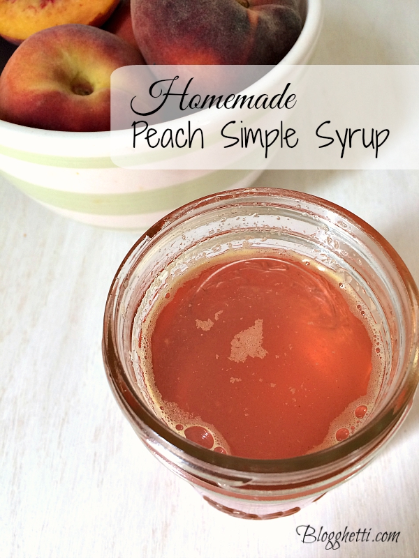 Peach Simple Syrup in mason jar with a bowl of fresh peaches in the background
