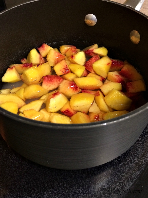 saucepan with diced peaches, water, and sugar