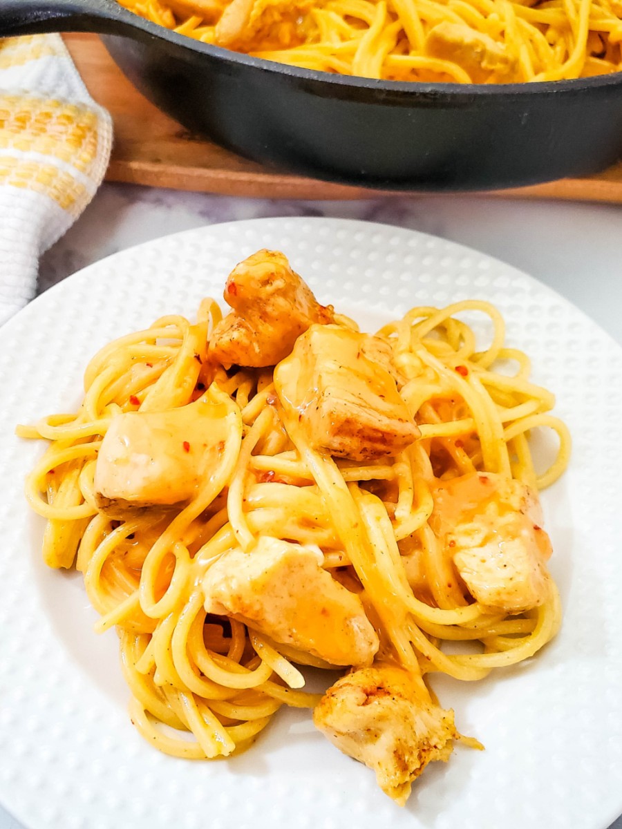 easy bang bang chicken pasta dinner made in cast iron skillet