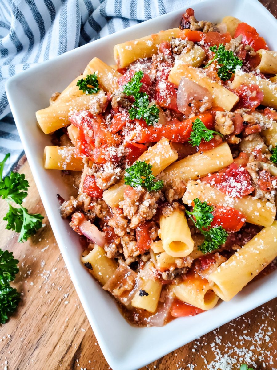 Spicy Sausage and Beef Rigatoni with Fire-Roasted Tomatoes in white bowl close up