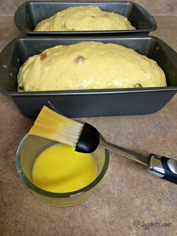 egg wash being added to babka bread dough that is ready to bake