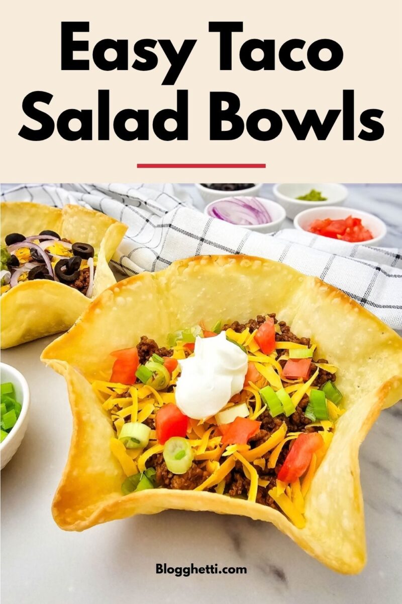 Close-up of a taco salad in a golden tortilla shell with ground beef, cheddar, tomatoes, green onions and sour cream. Text reads “Easy Taco Salad Bowls.”