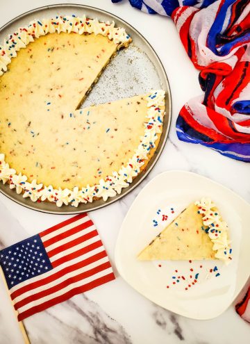 Easy Red, White, and Blue Giant Cookie Cake with slice on plate