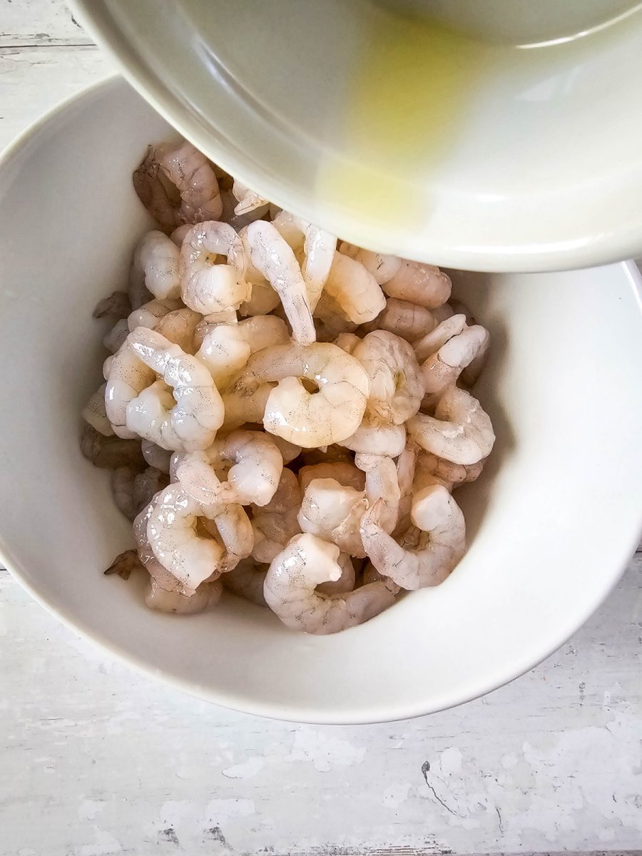 raw shrimp in bowl with olive oil