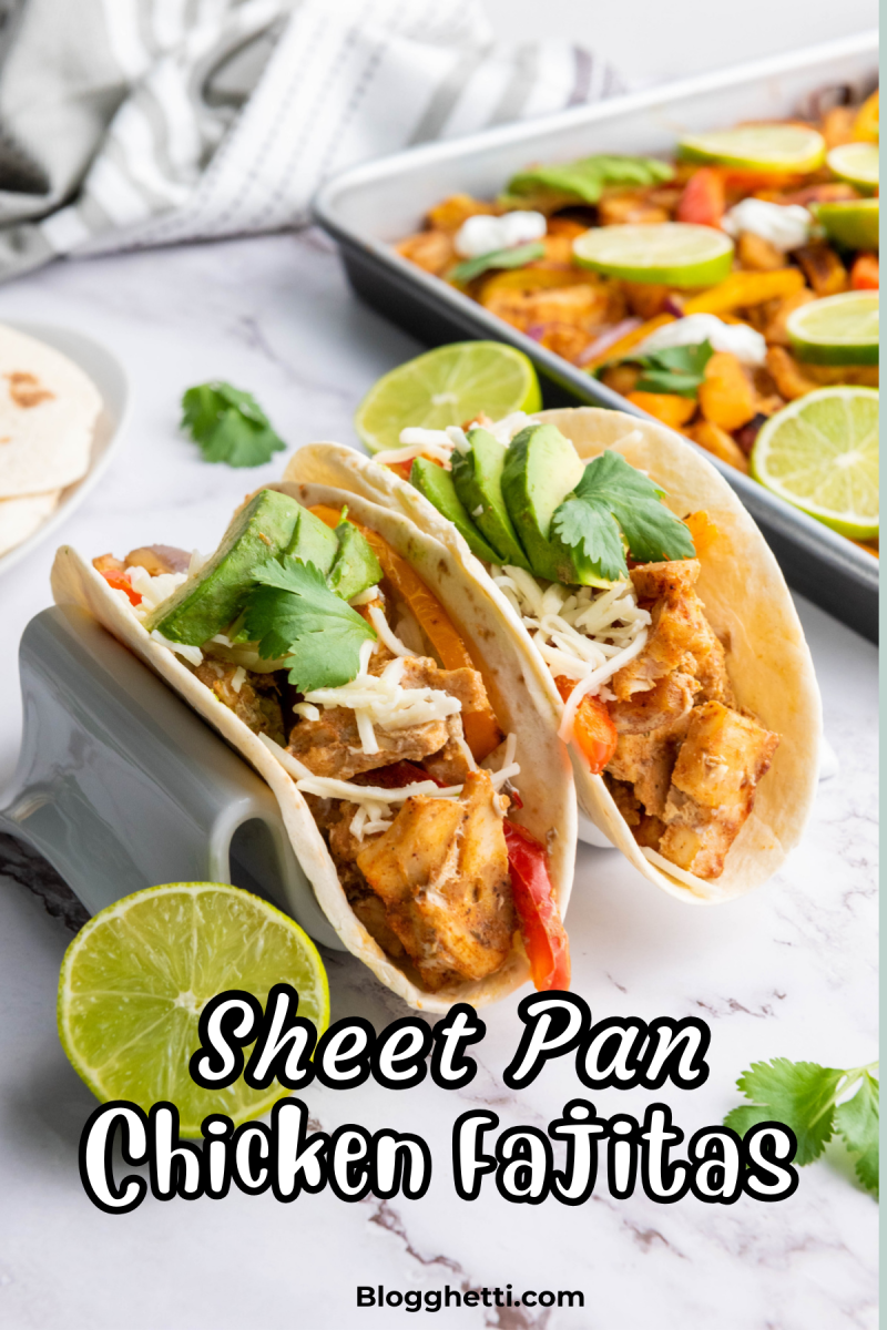 A close-up of two soft tortillas filled with Sheet Pan Chicken Fajitas, featuring seasoned chicken, bell peppers, shredded cheese, avocado slices, and cilantro. A sheet pan with additional fajita ingredients, lime slices, and a striped kitchen towel are in the background. The text overlay reads "Sheet Pan Chicken Fajitas," with "Blogghetti.com" at the bottom.