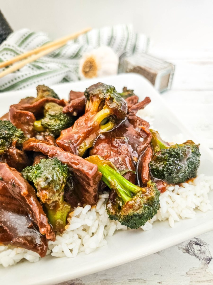 take out beef and broccoli on white plate