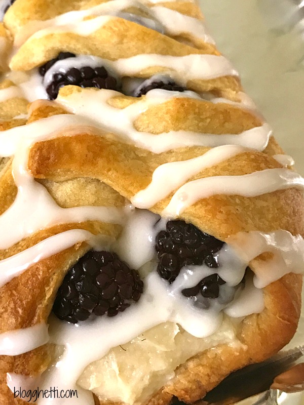 This Raspberry Cheese Danish Braid is so easy to make and it starts with a can of crescent dough. The danish is filled with cream cheese and fresh raspberries and then topped with a sweet glaze. Change up the fruit with your any of your favorites or a combination.