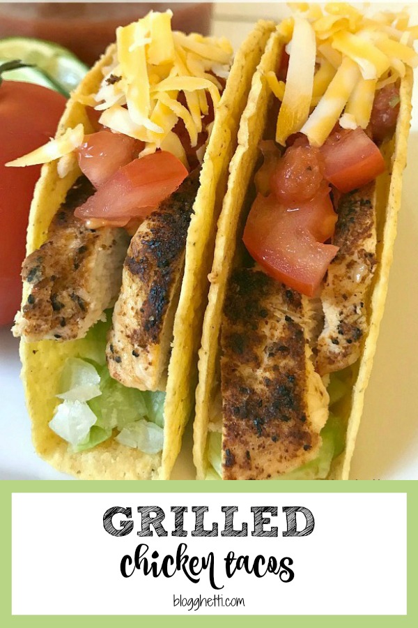 Two Grilled Chicken Tacos with cheese, lettuce, and tomatoes