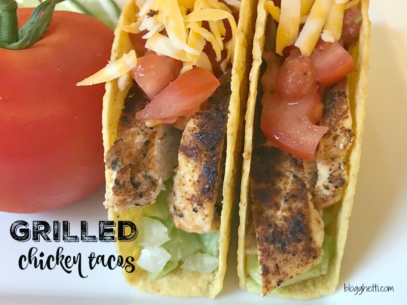 Two Grilled Chicken Tacos with cheese, lettuce, and tomatoes