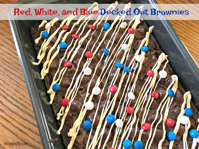 Red, White, and Blue Decked Out Brownies are the perfect patriotic summer treat Fudgy brownies filled with chocolate and M & M candies topped with marshmallows, more candy and drizzled with white chocolate.
