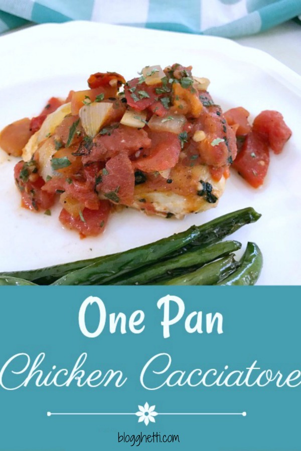 White plate with a serving of skillet chicken Cacciatore with roasted green beans