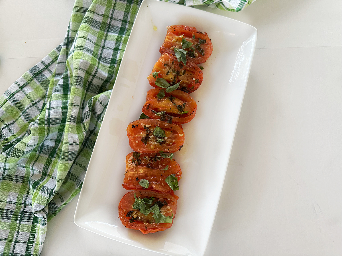 overhead view of grilled tomatoes with herbs