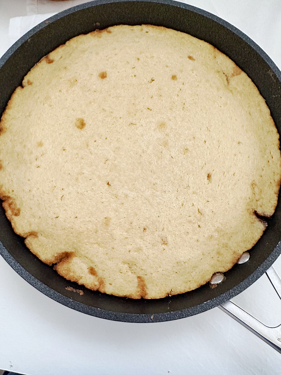baked peach cake cooling in skillet