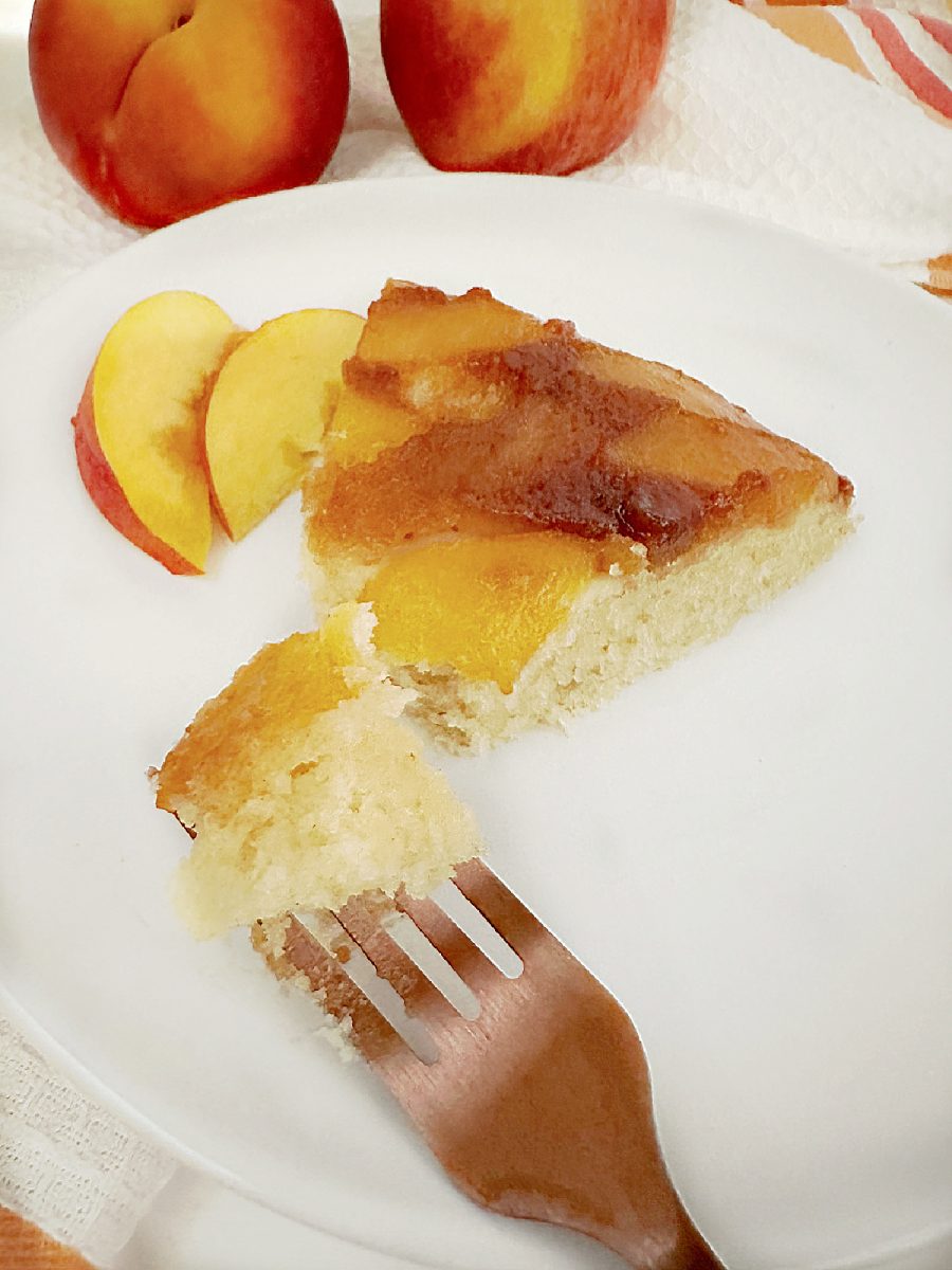 peach cake slice on white plate